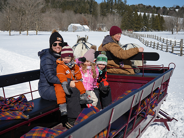 website Enjoying a break from the slopes with a horse drawn sleigh ride at Billings Farm- Nadeen, Eli (age 2), Ellie (age 4), and Joey (age 8) from Rochester, MA copy